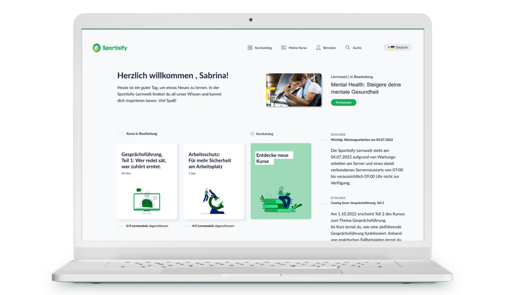 Ein weißer Laptop mit einem Screenshot der LMS-Benutzeroberfläche. Die Farben sind in Grüntönen abgestimmt.