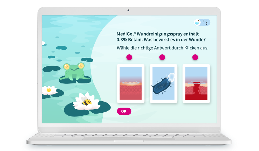 Laptop mit Screenshot as einem Training, es ist eine verspielt illustrierte Seite bei der es um ein Wundspray geht.